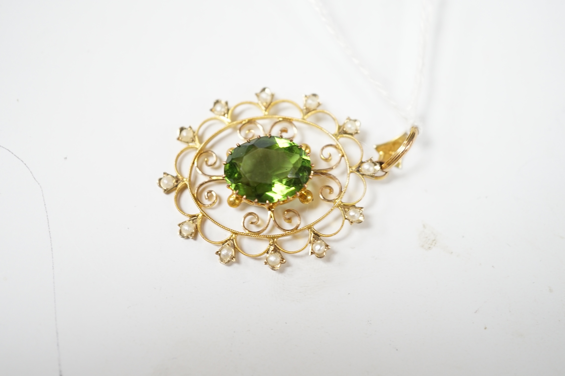 An early 20th century style 9ct, green paste and seed pearl set oval open work pendant, 38mm, 3.5 grams. Condition - good